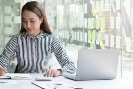 Person with pen on notepad