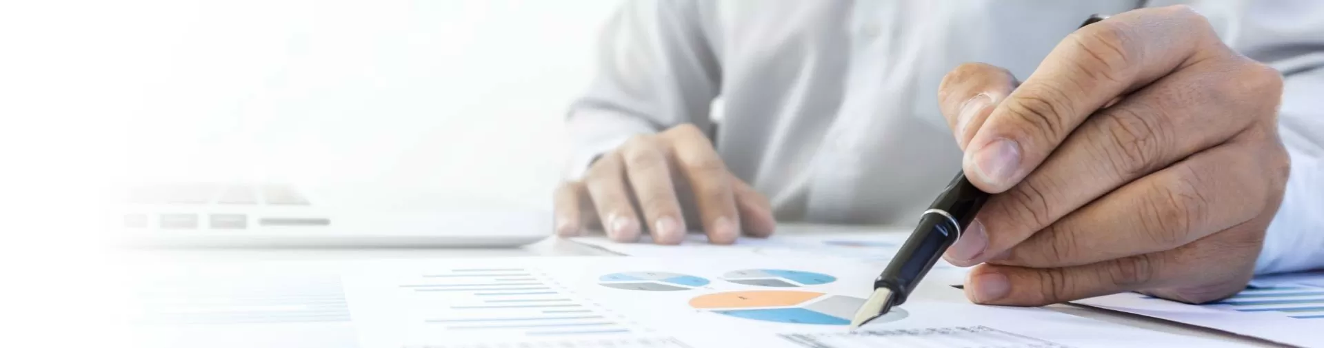 Person with fountain pen on charts